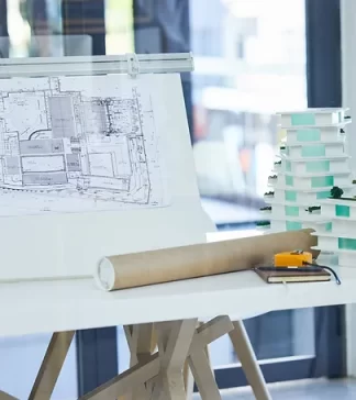 architecture-design-blueprints-office-desk-with-plans-building-model-construction-industry